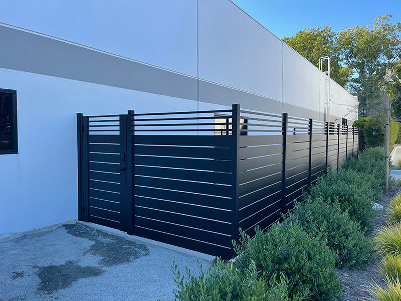Modern horizontal-slat aluminum fence and gate system installed at a Santa Ana, Orange County home