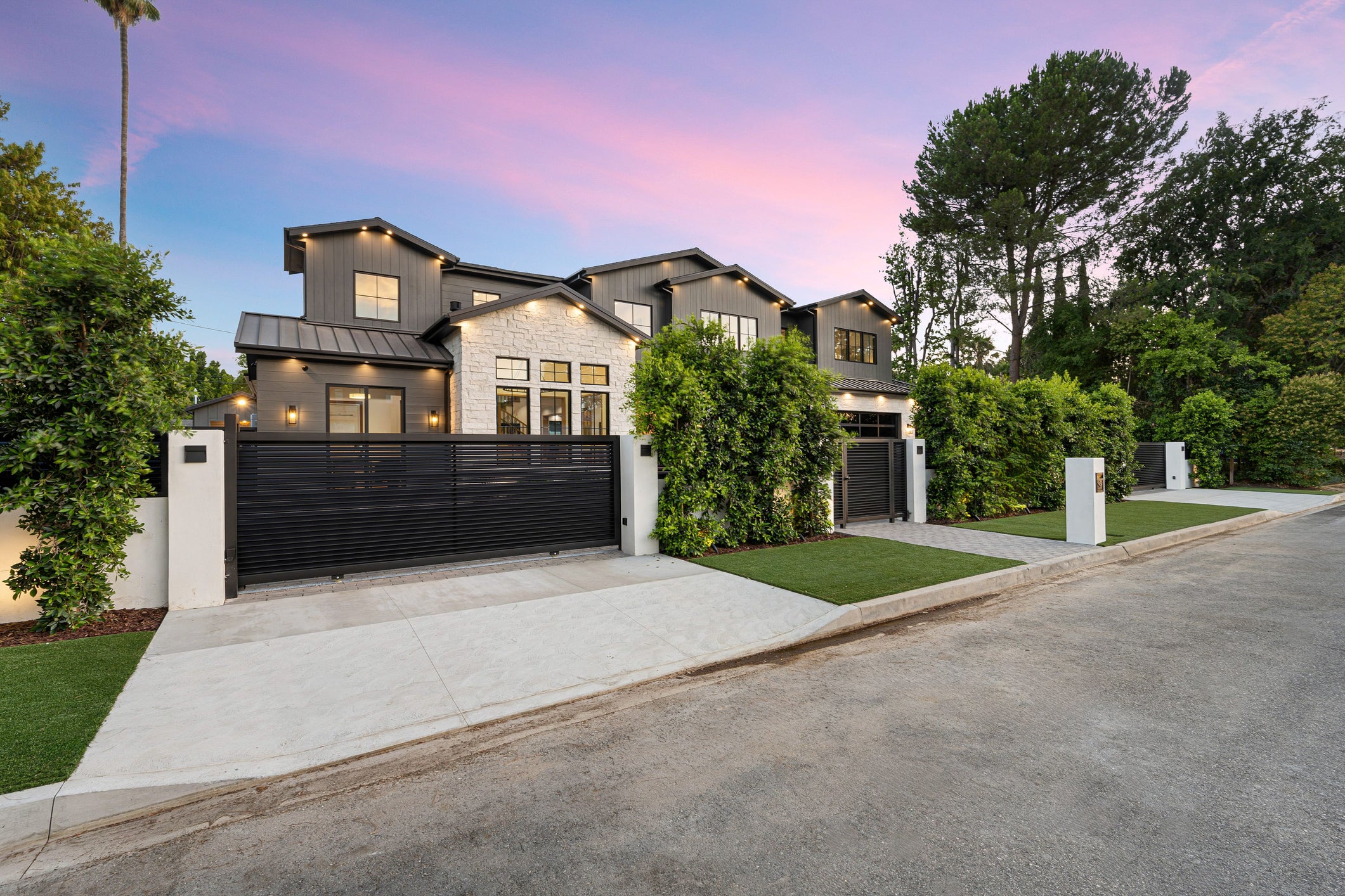 Enhance your home's curb appeal with custom iron driveway gates and fencing. This sleek, modern design combines security and elegance. Explore our premium gates and fencing solutions for residential properties. Contact us for custom designs and expert installation.