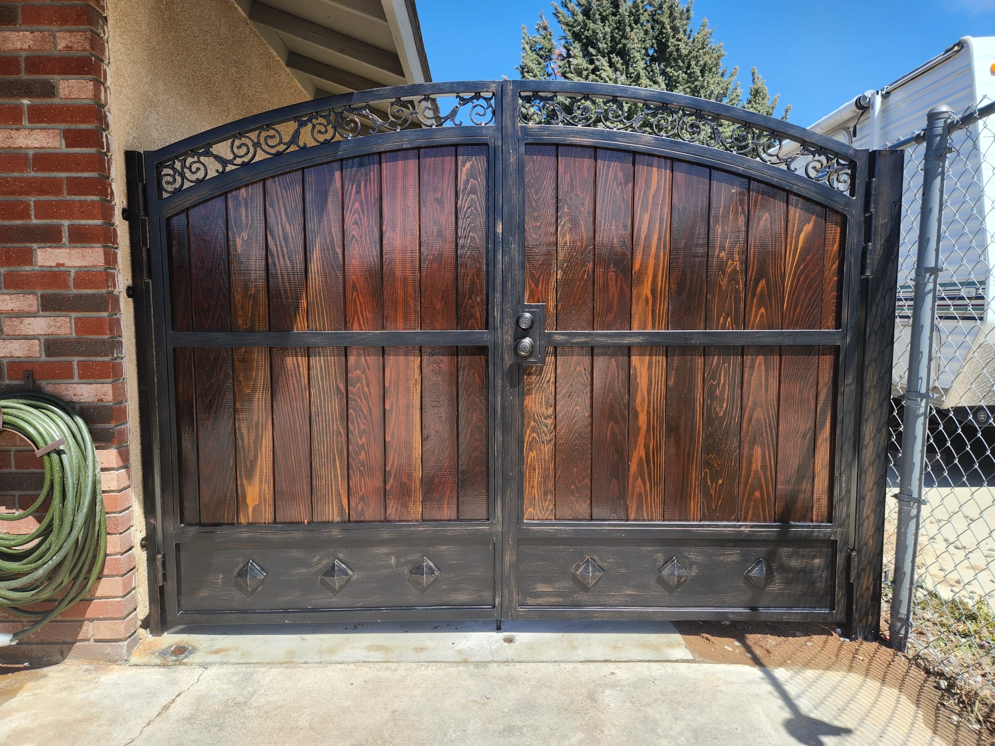 Warm wood-tone gate and fence, the natural look that composite fencing is engineered to replicate without the upkeep