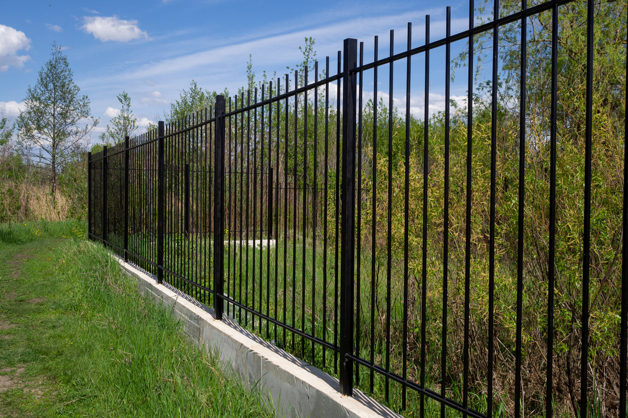 Commercial aluminum fence enclosure providing security and privacy for businesses and properties.